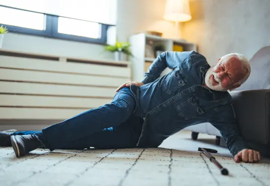 A man lying on the floor with his back and his hand on his hip